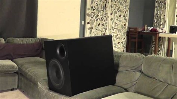 Can a subwoofer be placed behind a couch?
