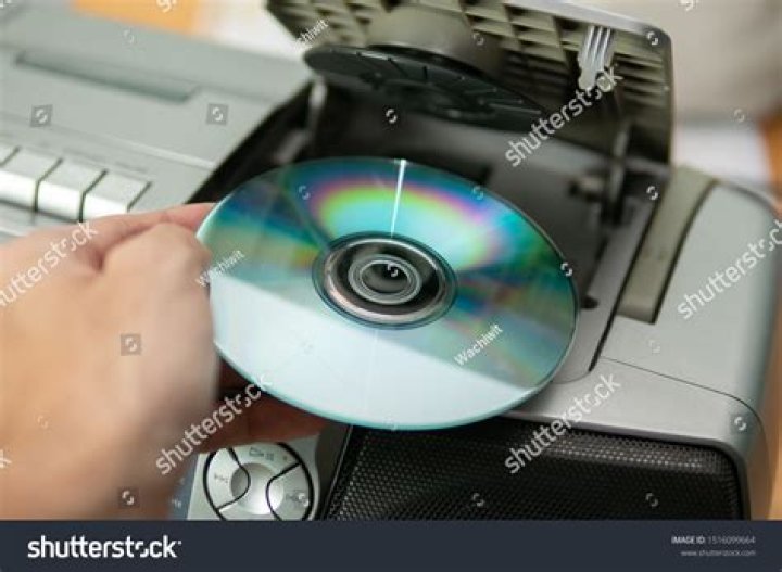How do I insert a CD into the CD player?