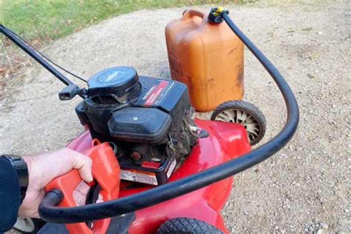 How do you get old gas out of a lawn mower?
