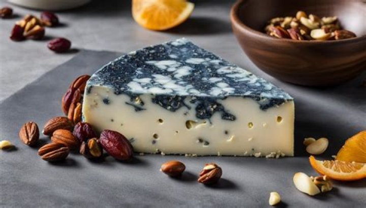 What causes the blackness in blue vein cheese?