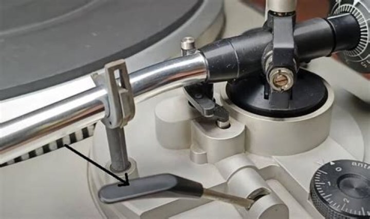 What is the function of a tonearm on a record?