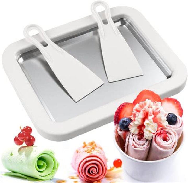 What is the purpose of the scraping blade inside the ice cream maker?