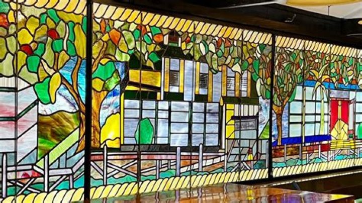 When did the Puritans start building stained glass windows?