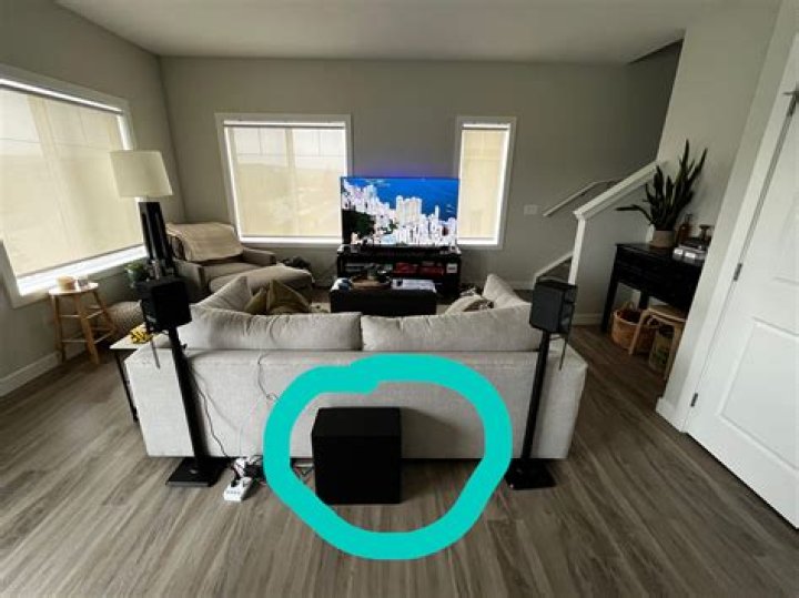 Where should a subwoofer be placed in a bedroom?
