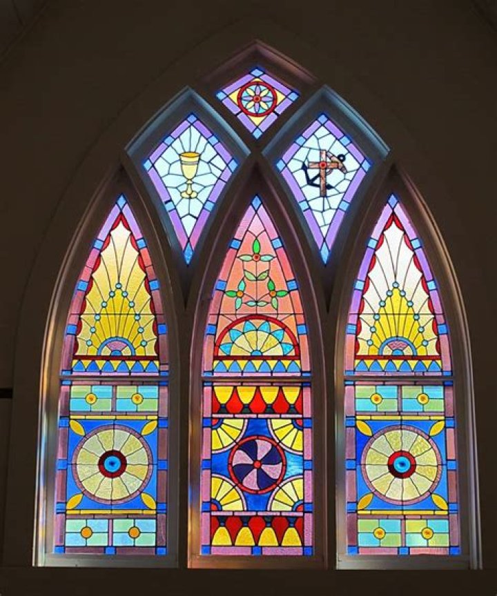 Why are stained glass windows so important in churches?